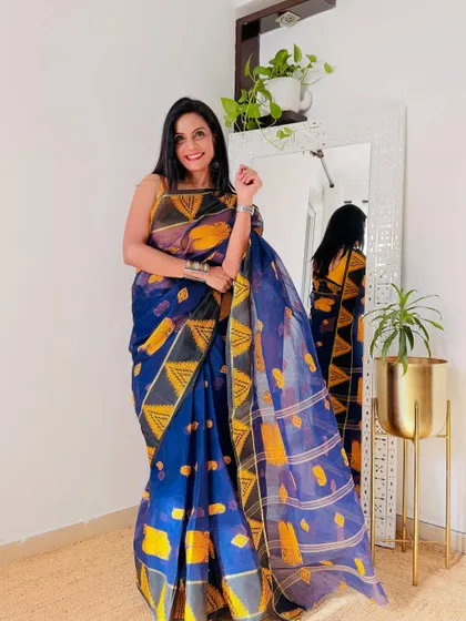 This blue and yellow Bengal Tant saree is a beautiful example of pure cotton handloom. It's lightweight, crisp, and perfect for hot weather.