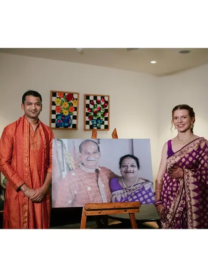 A truly special moment where Rachael and Viraj recreated a portrait of his parents. She is wearing his late mother's purple brocade saree, and he is in a custom Patiala and kurta inspired by his father's attire.