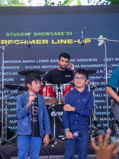 Two of our youngest performers taking the mic at the showcase. We believe it's never too early to start building stage confidence.