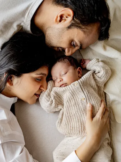 A quiet moment with mom, dad, and their newborn. These lifestyle shots, taken on the bed in your own home, are so pure and full of emotion.