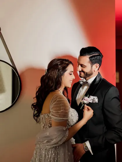 A sweet, candid moment of her adjusting his boutonnière. This close-up shot focuses on the small details and gentle interactions that make a pre-wedding shoot so special and personal.