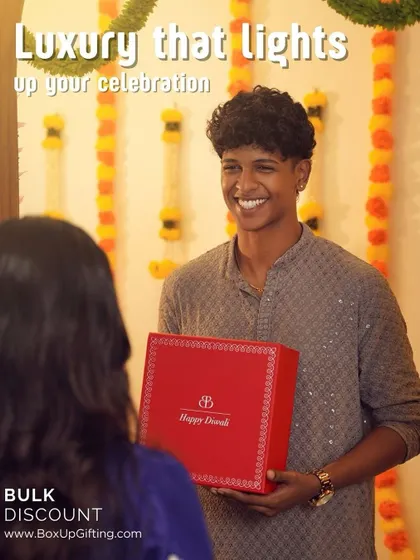 Luxury that lights up your celebration. A happy client receiving one of our signature red Diwali boxes, perfect for making a lasting impression. We offer bulk discounts for corporate orders.