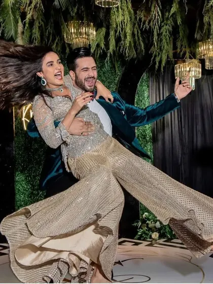 An iconic, fun-filled shot from Aly and Jasmin's performance. We choreograph dynamic poses that capture the energy of the dance and look amazing in photos.