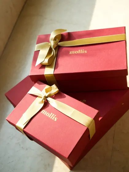 A stack of my burgundy and gold Diwali gift boxes, ready to be filled with handcrafted goodies.