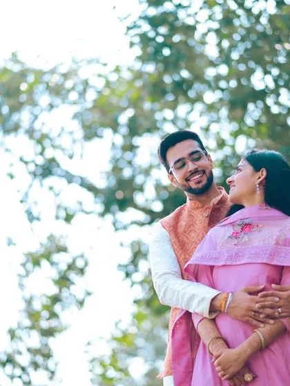 A classic, gentle embrace in a park setting. This timeless pre-wedding pose is all about showcasing the simple, comfortable love you share.