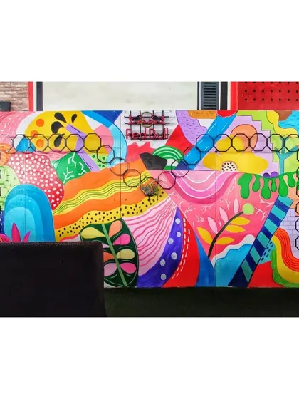 The completed abstract mural, adding a huge splash of color and energy to the cafe's seating area. This kind of doodle art is great for creating a youthful and modern vibe.
