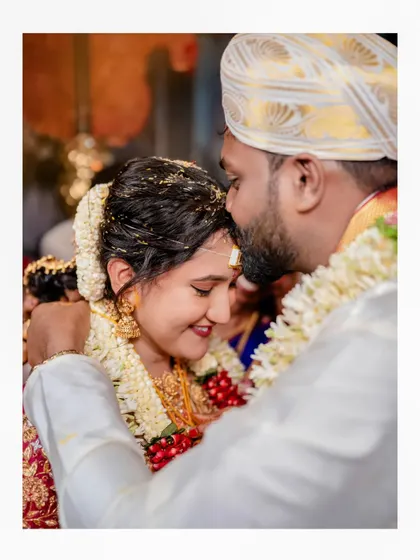A close-up, intimate moment of the groom embracing the bride, full of warmth and emotion.