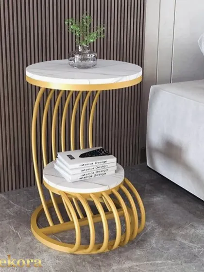 Referred to as our "crocodile style" table, this piece has a unique, wrap-around metal frame in gold. The dual marble-finish tops make it a highly sculptural and functional coffee table.