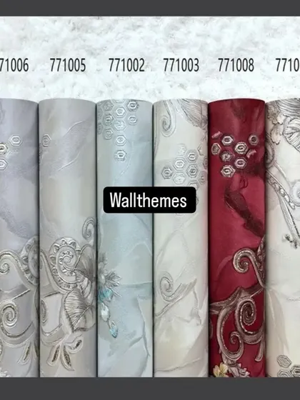 A lineup of eight wallpaper rolls from the same collection, showing a damask pattern in various colors like cream, blue, red, and green.