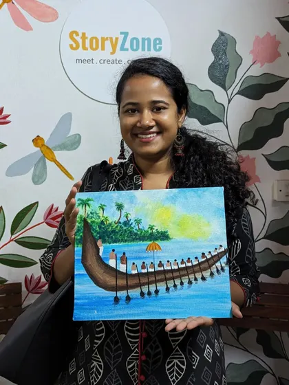 A participant with her beautiful Onam-themed canvas painting, featuring a traditional snake boat race.