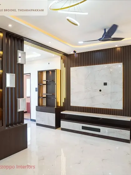 A duplicate image of the complete living room set at Jain's Pebble Brooke, showcasing the TV unit and partition together.
