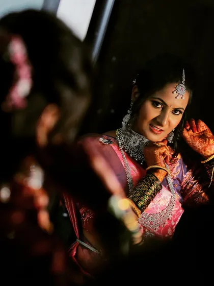 A bride's final look in the mirror before her ceremony, a moment of quiet reflection we love to capture.