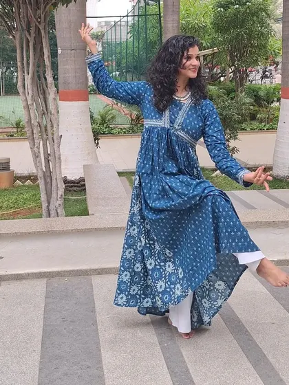 A full-length shot showing the graceful lines of this semi-classical dance pose.
