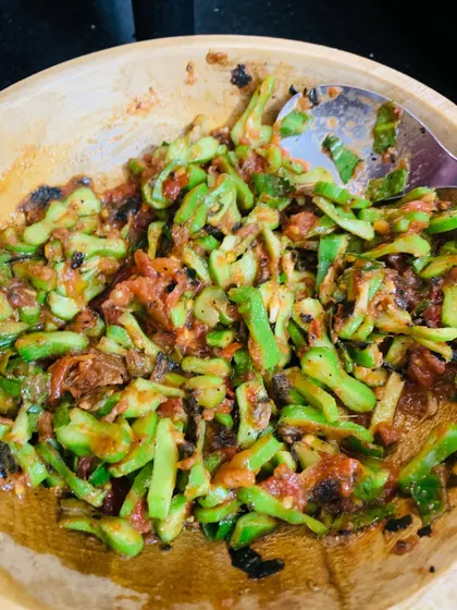 This is a simple chutney made from bitter gourd, which we call 'Asangba'. It's mixed with roasted tomatoes and chillies to balance the bitterness.