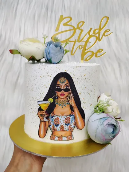 A stylish cake for a modern bride-to-be. The design features an illustration of a bride in traditional wear, complemented by fresh flowers.