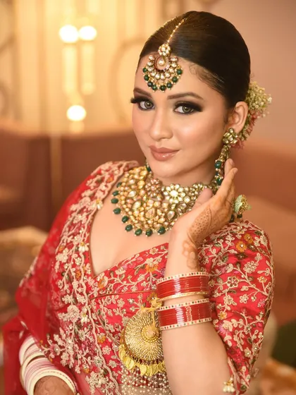 A close-up showcasing the large earrings and tikka from the bridal set, highlighting the detailed craftsmanship that makes my jewellery stand out.