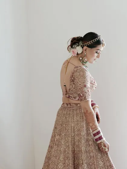 A delicate portrait of the bride, Bhavika, with flowers in her hair, capturing her serene beauty before the ceremony.