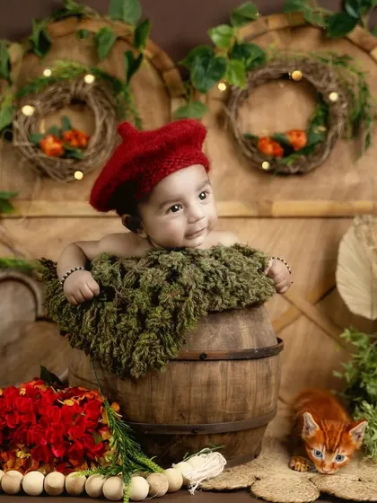 This 2-month-old looks so charming with his red beret in this rustic, woodland-themed setup.