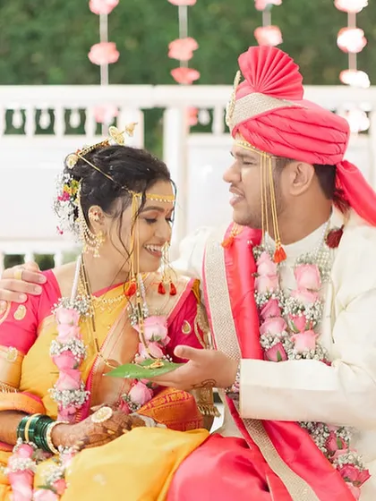 The couple sharing a lighthearted moment during their wedding rituals.