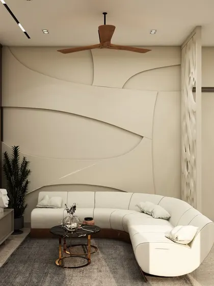 A unique curved sofa is paired with a stunning 3D accent wall, demonstrating our flair for creating custom, sculptural elements within a living space.