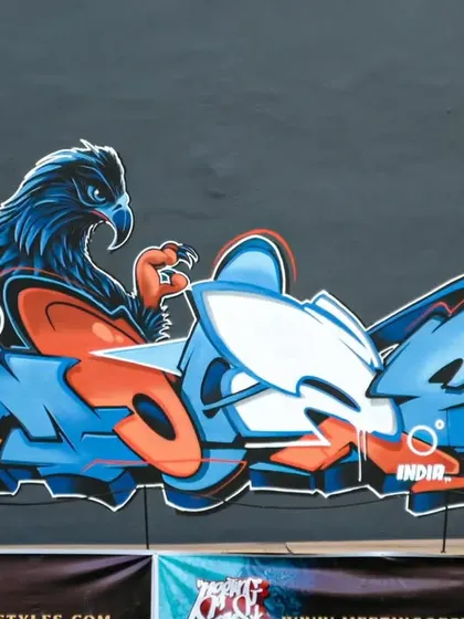 Taking my art global. This piece, featuring a fierce eagle, was my entry for the Meeting of Styles graffiti festival in Indonesia. It's an example of how I blend characters and letters for international events, sharing wall space with artists from around the world.