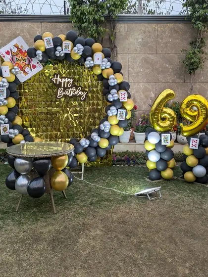The complete casino-themed setup with a gold foil backdrop, perfect for a fun and unique garden party.