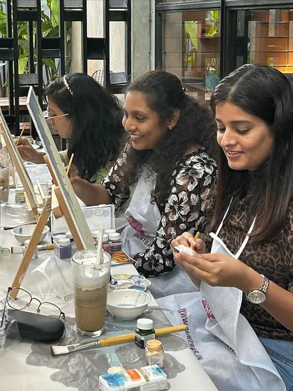 The smiles on their faces say it all. A corporate paint workshop is a fantastic way to boost morale and encourage creative thinking.