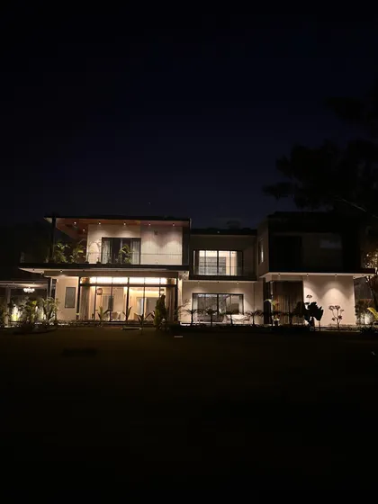 A wide shot of "The One" residence at night reveals the full effect of the landscape and architectural lighting. The entire property glows, with each layered volume and garden area carefully illuminated to create a cohesive and breathtaking nighttime vista.