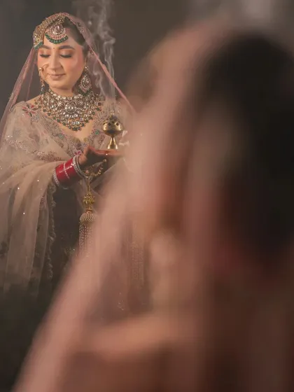 An artistic and moody shot of the bride during a ritual, with smoke adding a mystical effect.