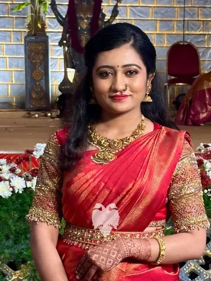 Another shot of the bride in her stunning red silk blouse, a timeless choice for the main ceremony.