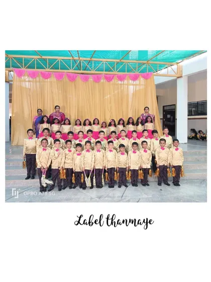 A large group of boys dressed in handsome gold satin shirts with red bow ties, creating a unified and polished look for their stage performance.