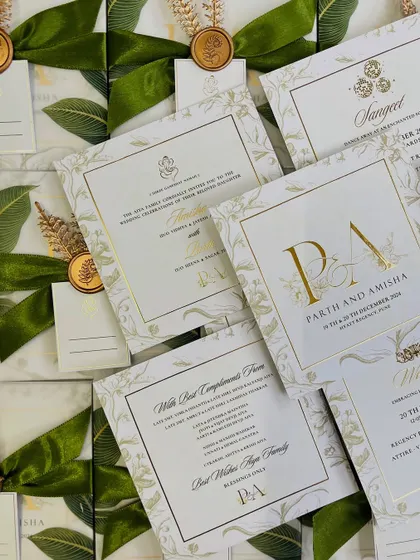 The full set of inserts for the P&A wedding, including the main invite, function details, and a compliments card, all designed with a cohesive and luxurious ivory and gold floral theme.