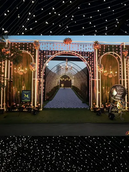 The full view of the grand sangeet entrance. The illuminated arches and starlit tunnel create a spectacular first impression, promising a night of glamour and celebration.