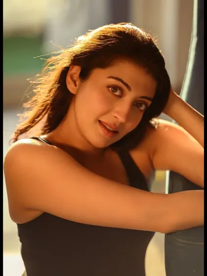 A close-up of Pranitha, where the focus is on her gentle expression. The backlighting from the sun creates a beautiful halo effect in her hair, adding a touch of magic.