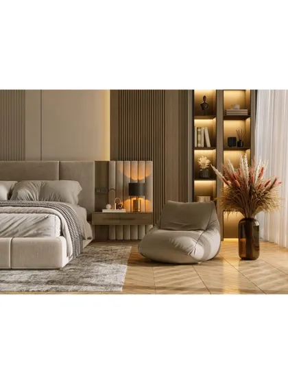 A bedroom that exudes warmth and texture. We used vertical wood paneling, soft backlighting, and a neutral color palette to create a cozy and inviting atmosphere, complete with a comfortable reading nook.
