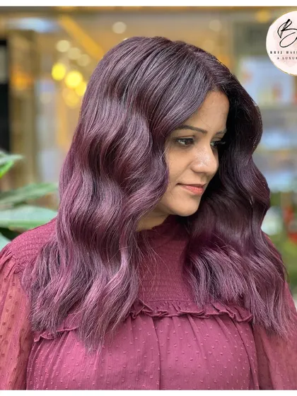 A side view of the bold grape wine color, with soft waves that enhance the rich, vibrant hue.