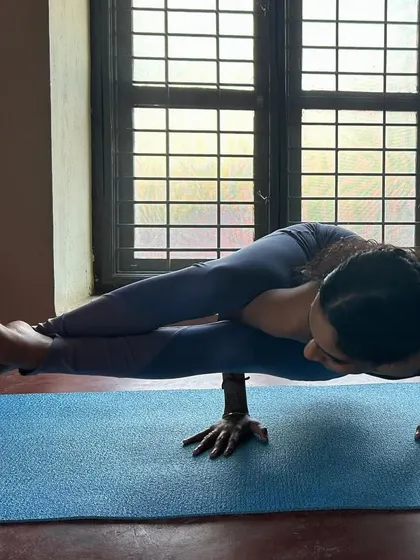 A steady hold in Astavakrasana (Eight-Angle Pose). This posture teaches us to find stability and grace even in challenging situations.