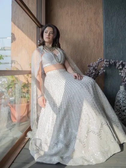The sunlight catching the details of this all-white lehenga makes it look even more magical. It's a testament to how location and lighting can enhance a look.