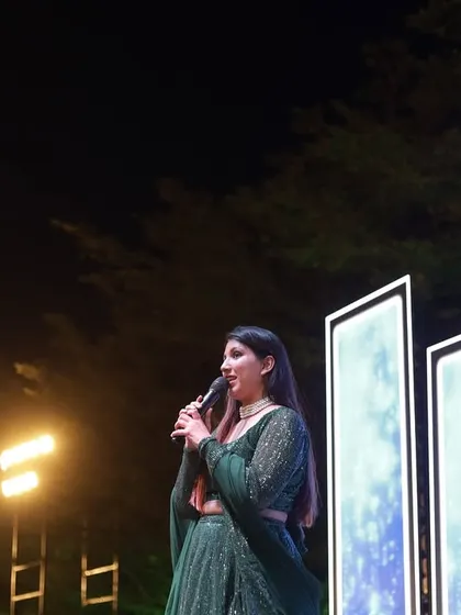A side profile of me hosting an outdoor sangeet, with the beautiful night sky as a backdrop.