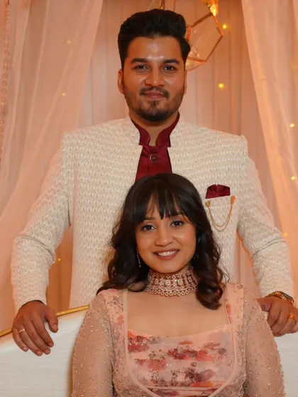 A classic portrait of the engaged couple. Her makeup is soft and natural, and her hairstyle with bangs frames her face beautifully.