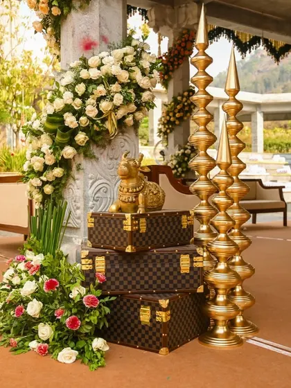 A luxurious detail shot featuring a golden Nandi statue placed on high-end luggage, blending tradition with modern luxury.