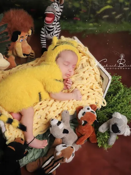 A different angle of our little tiger cub, sleeping peacefully amongst his animal friends. The details in the costume and the surrounding plush toys make this shot so special.