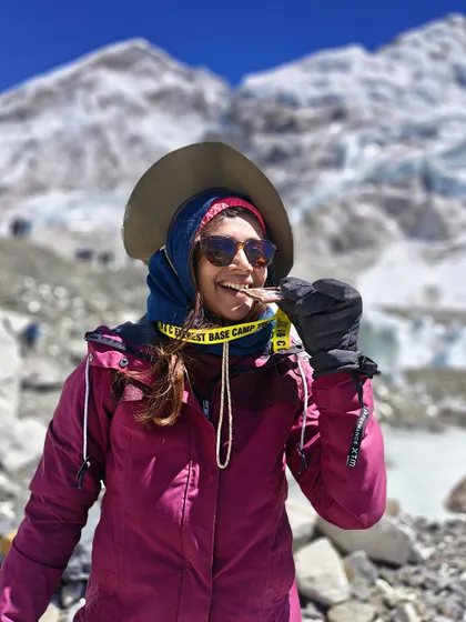 A moment of pure joy and a well-deserved chocolate break at Everest Base Camp. It's the small celebrations that make the big achievements even sweeter.