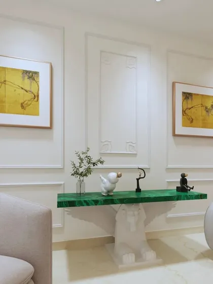 A close-up of a custom console table with a striking green marble top and a sculpted base, an example of our bespoke furniture pieces.