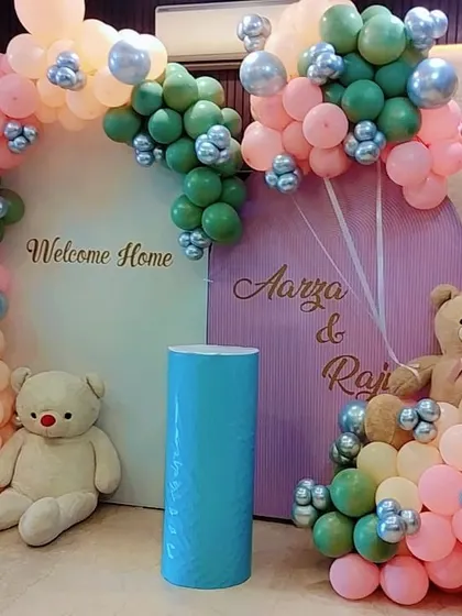 A beautiful welcome home decoration for twins Aarya and Raj. I used a pastel color palette of pink, green, and peach for the balloon arch and incorporated two large teddy bears to complete the sweet theme.