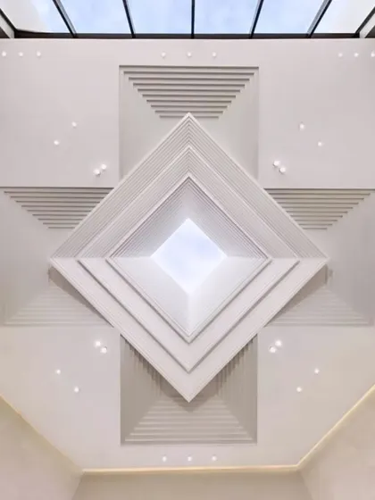 A stunning example of a multi-layered POP ceiling that creates an incredible sense of depth. The pyramid-like geometric design draws the eye upward, making it a powerful architectural statement.