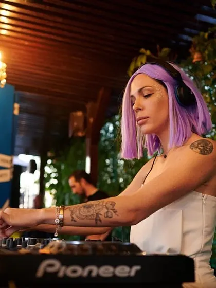 A photo from a white party gig with purple hair. The elegant chandelier and green plants made a beautiful setting.