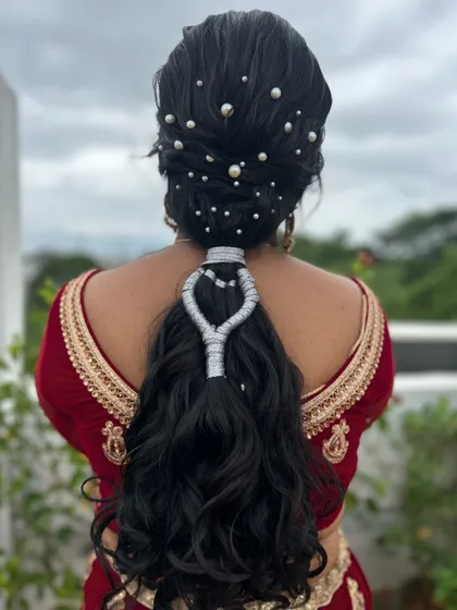 A closer look at the intricate thread work and pearl details on this creative ponytail.