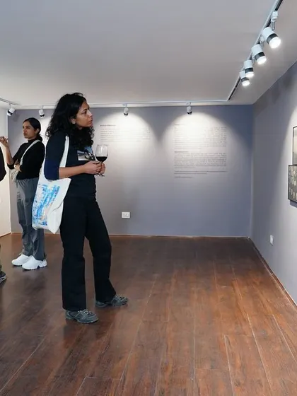 A visitor enjoying the gallery atmosphere during the opening night of "Dreams of a Summer Past."