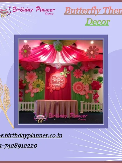A whimsical Butterfly theme party. The backdrop is decorated with pink fabric draping, large paper flowers, and delicate butterflies to create an enchanting garden atmosphere.